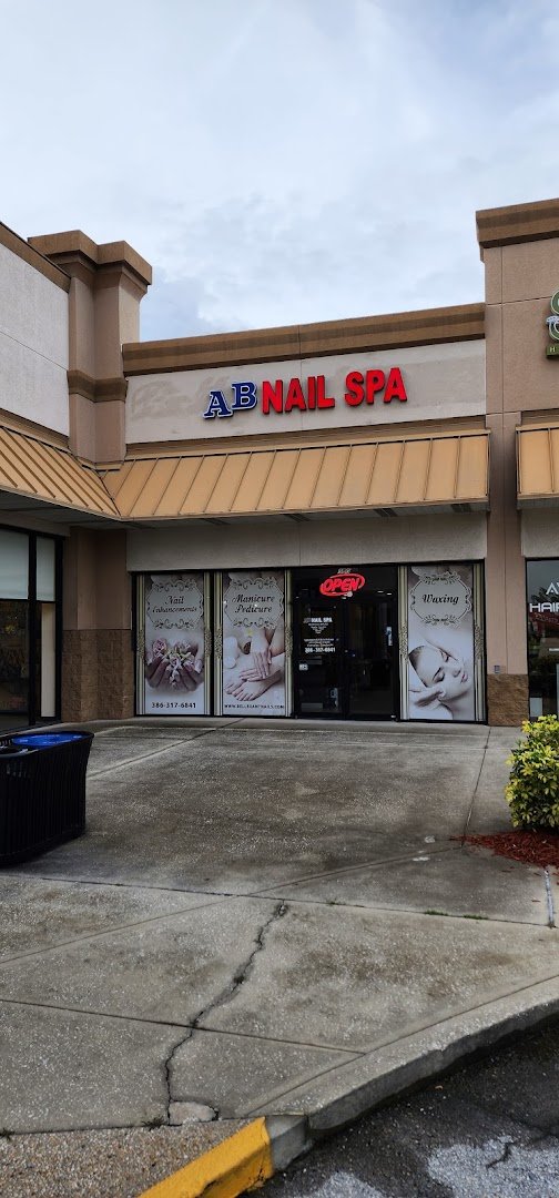 Nail salon interior with manicure stations and polish displays.