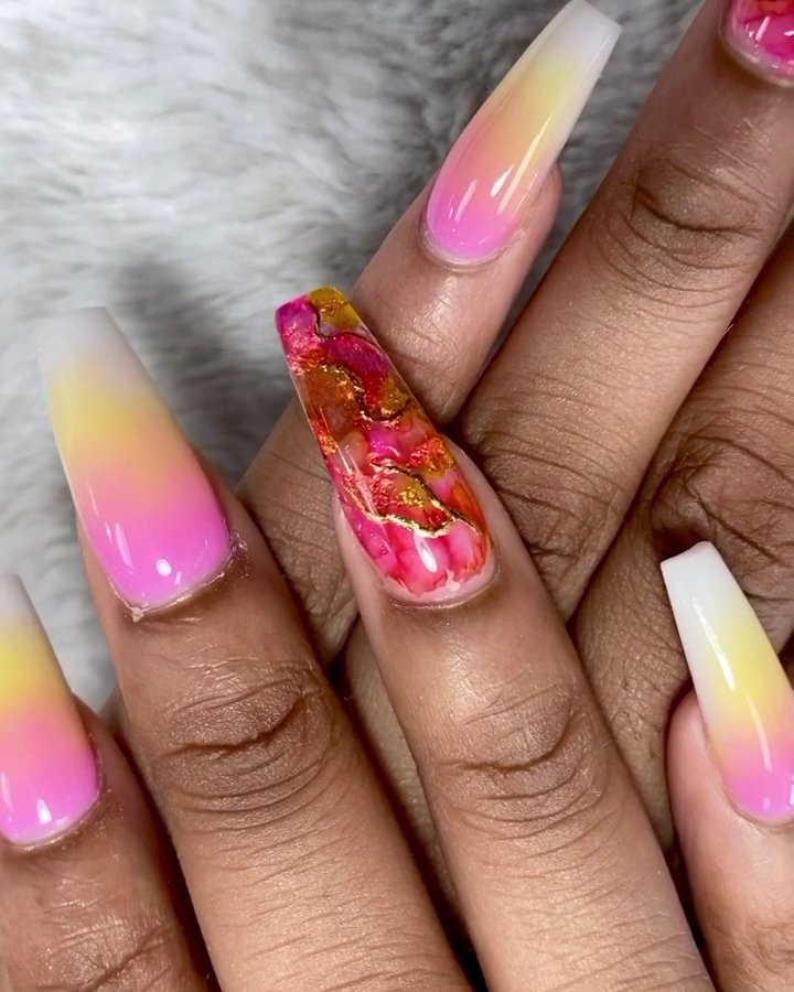 Acrylic nail set shown with glossy finish and shaped tips.